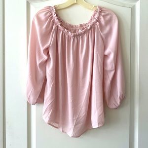 Off the shoulder pink blouse.